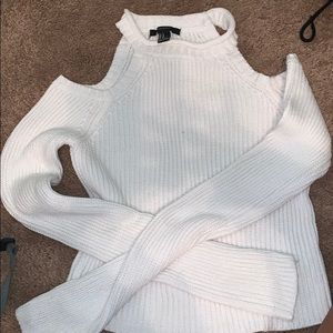 White sweater cut at shoulders